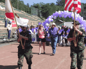 The Color Guard and 2013 "Survivor of the Year" Al O'Brien lead the opening lap
