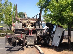 Big Rig without trailer into pickup truck on its side.