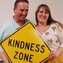 Kindness Coordinator Jim Bergantz, with daughter Jill, hold up a Kindness Zone sign