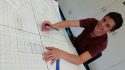 Student Julian Petty, working on a canvas logo for the Sesquicentennial.