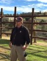 PAWS Senior Elephant Keeper Brian Busta addresses visitors as Asian Bull Elephant Nicholas mugs for cameras behind him