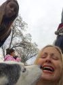 93.5 KKBN Afternoon DJ Tori James getting kisses from Cierra the elf at the Interfaith Coat Drive and Santa-Fly-in at Standard Park