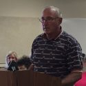 Audience member Jim Costello addresses board