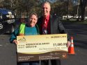 Interfaith Services Director Cathie Peacock accepts check from Black Oak Casino GM Aaron Moss at the Santa-Fly-in and coat drive For Interfaith at Standard Park