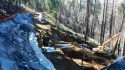 Construction contractors have dug down 50 feet and are working around the clock to repair and reopen the Big Oak Flat road