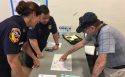 CAL Fire personnel helping resident at Mariposa High Assistance Center