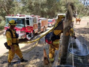 Mountain View Fire Dept showing Mutual Aid-plus during Detwiler Fire, filling a water trough for local horses.