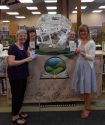 Tuolumne County Library staff members show off Passport Basket