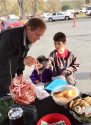 KVML's Mark Truppner with kids getting candy canes at 2017 Santa Fly-in and Interfaith Coat Drive