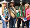 2018 Frog Jump Champion Laura-Kitchell, right hoists trophy next to Saddle Queens