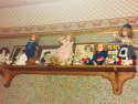 Utica Mansion a detail of the nursery wallpaper and shelf with Shirley Temple collectibles