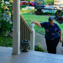 Utica Mansion a visitor enters from lot by Utica Park to climb the front porch stairs and tour the home