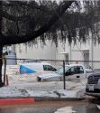 AT&T service vehicles under water at building parking lot