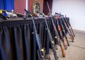 Guns lined up at California Attorney General press conference in Sacramento