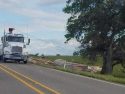 Overturned semi and trailer full of lumber