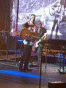 Eric Church peering from stage sans aviators to read Makena Wallace's sign Sept 29 2019