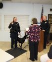Deputy City Clerk Susan Wenger swearing in K9 Valkyrie with Officer McDearmid and Chief Ellis