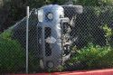 Overturned vehicle that smashed through fence behind Walmart