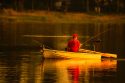 man in red cap and shirt fishing in lake