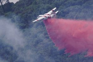 Columbia air tanker 83 dropping retardant on the fire off West Stockton Road
