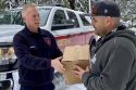 Ebbetts Pass Fire Protection Chief Mike Johnson delivering an American Red Cross emergency food box to a family snowed in by this storm, Blue Lake Springs