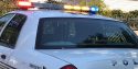 Arrested suspect in the backseat of SPD patrol vehicle