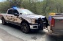 Suspect's truck that rolled back into patrol vehicle