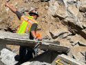 Caltrans crews putting in drainage pipe to take storm water off the roadway