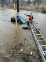 Rescue crews work on truck found in flooded area off Rail Road Flat Road