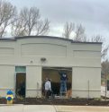 Workers check out the damage to the Tuolumne Resiliency Center after a vehicle crashes into it