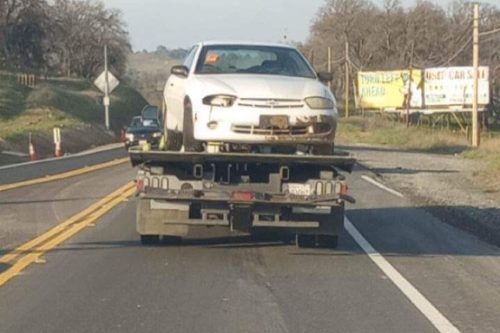 Flooded car left on Red Hills Road being towed