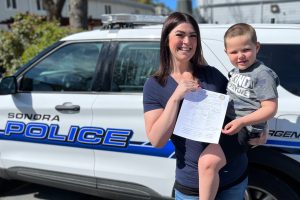Brittaney Sutton and Wyatt holding form at Sonora Police Station