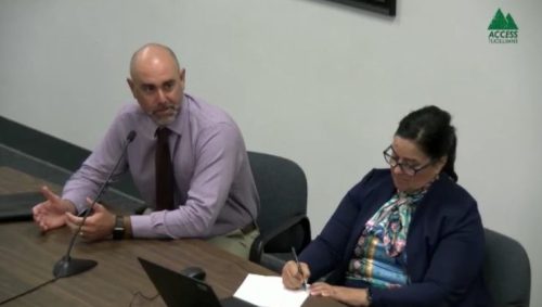 Justin Myers of Caldwell Insurance provides advice to board of supervisors as Dore Bietz of Tuolumne County OES writes notes.