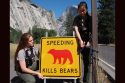 Yosemite wildlife rangers maintaining a dual-sided 'Speeding kills bears' sign. These are placed in locations where vehicles have hit wildlife.
