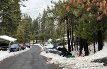 Snow removal limited by cars parked along a residential street