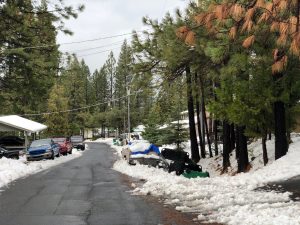 Snow removal limited by cars parked along a residential street