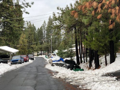Snow removal limited by cars parked along a residential street