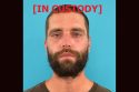 Dominic Schmitz TCSO booking photo with "in custody" across it