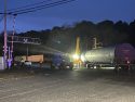 Bulldozers with a crane working to remove the derailed cars