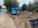 Mud being removed near the tracks where the train derailed