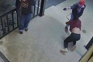Security video of Gelhaus with female trying to stop him from firing through the bar door -- MCSO photo