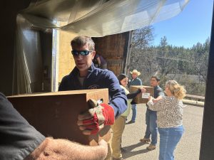 STF Supervisor Jason Kuiken helping to unload trees to plant