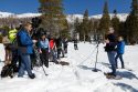 California Department of Water Resources Snow Surveys and Water Supply Forecasting Unit Water Engineers Andy Reising, right, and Anthony Burdock conduct the fourth media snow survey of the 2024 season at Phillips Station in the Sierra Nevada. Gov. Gavin Newsom, center, and California Natural Resources Agency Secretary Wade Crowfoot watch the process. The survey is held approximately 90 miles east of Sacramento off Highway 50 in El Dorado County.  Photo taken April 2, 2024.  