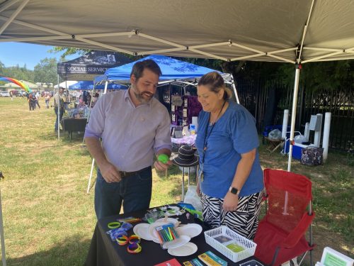 Supervisor Ryan Campbell speaks with vendor at Sonora Pride Event