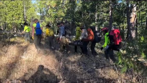 Beth Watson was carried by SAR members to a helicopter