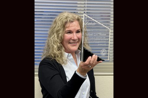 Juliana Feriani holding Women in Leadership Award at the TCBOE board Monday meeting