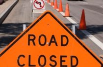 Road closed sign with cones
