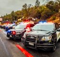 Tuolumne County Sheriffs Deputies line Stockton Street in Sonora to cheer on the Wildcat football team buses heading to the championship game