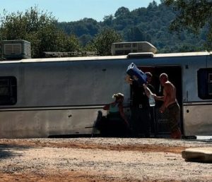 Officials help provide water for pets of people living at Camp Justice