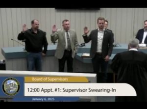 Mike Holland, Steve Griefer and Jaron Brandon take the oath of office